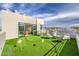 Rooftop deck with putting green, modern seating, and sliding glass doors showcasing a luxurious living experience at 4077 Heron Fairway Dr, Las Vegas, NV 89141