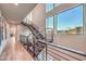 Modern staircase with wood treads, metal railings, and large windows offering scenic views at 4077 Heron Fairway Dr, Las Vegas, NV 89141