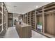Expansive walk-in closet featuring custom built-in shelving and storage, plus a central island at 4077 Heron Fairway Dr, Las Vegas, NV 89141