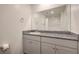 Bathroom features granite counters, a large mirror, and gray cabinets at 4234 Lunar Canyon Ave, North Las Vegas, NV 89084