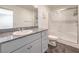 Bathroom features granite counters, a large mirror, white cabinets and a glass-enclosed shower at 4234 Lunar Canyon Ave, North Las Vegas, NV 89084