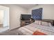 Cozy bedroom featuring a neutral color scheme, large TV, and comfortable-looking bed at 4234 Lunar Canyon Ave, North Las Vegas, NV 89084