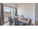 A well-lit dining area with a sliding glass door with a view of the backyard at 4234 Lunar Canyon Ave, North Las Vegas, NV 89084