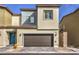 Charming two-story home with a brown two-car garage door and a blue front door at 4234 Lunar Canyon Ave, North Las Vegas, NV 89084