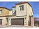 Two-story home showcasing a two-car garage door and manicured landscaping at 4234 Lunar Canyon Ave, North Las Vegas, NV 89084