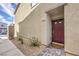 Home featuring a red front door with a brick paved walkway and gravel landscaping at 4234 Lunar Canyon Ave, North Las Vegas, NV 89084