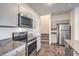 Well-equipped kitchen boasts stainless steel appliances, granite countertops, and stylish light gray cabinetry at 4234 Lunar Canyon Ave, North Las Vegas, NV 89084