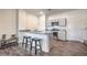 Bright kitchen with granite countertop island, stainless steel appliances, and laminate flooring at 4234 Lunar Canyon Ave, North Las Vegas, NV 89084