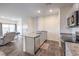 Contemporary kitchen flows into the dining and living areas with stainless steel appliances and stone counter tops at 4234 Lunar Canyon Ave, North Las Vegas, NV 89084