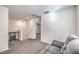 Comfortable living room with plush gray carpeting, modern fixtures, and neutral wall color at 4234 Lunar Canyon Ave, North Las Vegas, NV 89084