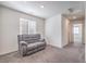 Carpeted living room with a gray sofa, natural light, and recessed lighting at 4234 Lunar Canyon Ave, North Las Vegas, NV 89084