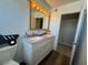 Double sink vanity with a wood-framed mirror and light at 4262 Tarkin Ave, Las Vegas, NV 89120