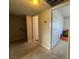 Carpeted hallway with doors leading to rooms and natural light coming through the window at 4262 Tarkin Ave, Las Vegas, NV 89120