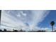 Low angle shot of sky, sparse clouds, and palm trees at 4262 Tarkin Ave, Las Vegas, NV 89120