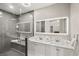 Bathroom featuring a modern double sink vanity, illuminated mirror and a glass enclosed shower at 4689 Kristen Ln, Las Vegas, NV 89121