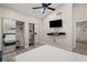 Bright bedroom with mirrored closet, ceiling fan, wall-mounted TV and ensuite bath at 4689 Kristen Ln, Las Vegas, NV 89121