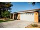 Home featuring a two-car garage, complemented by desert landscaping for easy maintenance at 4689 Kristen Ln, Las Vegas, NV 89121