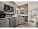Modern kitchen with gray cabinets and stone countertops at 4689 Kristen Ln, Las Vegas, NV 89121