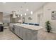 Open kitchen with spacious island, stainless steel appliances and dining views at 4689 Kristen Ln, Las Vegas, NV 89121
