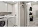 Bright laundry room with white cabinets and modern washer and dryer at 4689 Kristen Ln, Las Vegas, NV 89121