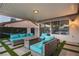 Inviting covered patio with stylish outdoor furniture, fire pit, and artificial turf at 4689 Kristen Ln, Las Vegas, NV 89121