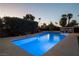 Stunning pool with vibrant blue water, spa, and lush landscaping for backyard enjoyment at 4689 Kristen Ln, Las Vegas, NV 89121