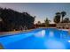Inviting pool features clean, sparkling blue water and meticulously maintained landscaping at 4689 Kristen Ln, Las Vegas, NV 89121