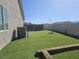 This spacious back yard features artificial grass and a concrete block fence at 5051 Fairmont St, Pahrump, NV 89061