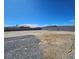 Expansive backyard area with gravel, sand and a tall block wall surrounding the property at 5051 Fairmont St, Pahrump, NV 89061