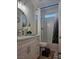 Bathroom featuring a vanity with granite counters, a round mirror, a toilet, and shower with a curtain at 5051 Fairmont St, Pahrump, NV 89061