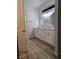 This spacious bathroom features dual sinks with white cabinetry and hard surface flooring at 5051 Fairmont St, Pahrump, NV 89061
