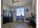 Bedroom featuring wood floors, a window, black storage cabinet, desk, chair, and wall art at 5051 Fairmont St, Pahrump, NV 89061
