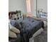 Bedroom featuring wood floors, a gray rug, a bed with a gray comforter and throw pillows at 5051 Fairmont St, Pahrump, NV 89061