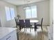 Bright dining area featuring a wood table, modern light fixture, and updated floors at 5051 Fairmont St, Pahrump, NV 89061