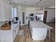 Modern kitchen with white cabinets, quartz countertops, a large island, and stainless steel appliances at 5051 Fairmont St, Pahrump, NV 89061