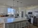 Bright kitchen featuring white cabinetry, stainless appliances and a large island with seating at 5051 Fairmont St, Pahrump, NV 89061