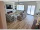 A bright living room with a decorative stone accent wall and modern electric fireplace at 5051 Fairmont St, Pahrump, NV 89061