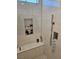 This shower features a built in niche and seat and a handheld shower fixture at 5051 Fairmont St, Pahrump, NV 89061