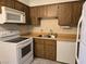Functional kitchen with standard appliances, light countertops, and wood cabinetry at 519 Fir St # G, Boulder City, NV 89005