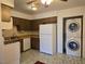 Kitchen view with wood cabinets, standard appliances, and in-unit laundry at 519 Fir St # G, Boulder City, NV 89005