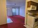 Open-concept living room connects to the kitchen, brightened by a sliding glass door at 519 Fir St # G, Boulder City, NV 89005