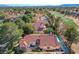 Aerial view of a residential area, highlighting homes with pools and lush greenery near a golf course at 5429 Painted Sunrise Dr, Las Vegas, NV 89149