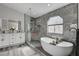 Beautifully renovated bathroom with a soaker tub and marble tile finishes at 5429 Painted Sunrise Dr, Las Vegas, NV 89149