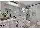 Bright bathroom with a large mirror, white cabinets, modern fixtures, and a stylish glass enclosed shower at 5429 Painted Sunrise Dr, Las Vegas, NV 89149