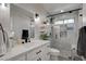 Bright bathroom featuring a vanity with a white quartz countertop and a modern glass-enclosed shower at 5429 Painted Sunrise Dr, Las Vegas, NV 89149