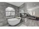 Luxurious tub with stylish marble tiling adjoining to main bedroom at 5429 Painted Sunrise Dr, Las Vegas, NV 89149