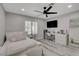 Cozy bedroom with a large bed, desk, and a ceiling fan, all enhanced by natural light at 5429 Painted Sunrise Dr, Las Vegas, NV 89149
