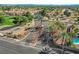 A gated community is surrounded by mature trees, green spaces and a golf course at 5429 Painted Sunrise Dr, Las Vegas, NV 89149