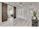 Inviting foyer with wood-look flooring, barn door and an elegant front door with decorative glass panels at 5429 Painted Sunrise Dr, Las Vegas, NV 89149