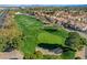 A manicured golf course is surrounded by lush landscaping and beautiful homes at 5429 Painted Sunrise Dr, Las Vegas, NV 89149